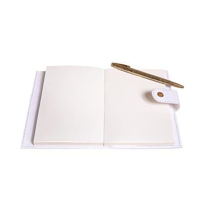Open Rewrite notebook with a gold pen on blank pages